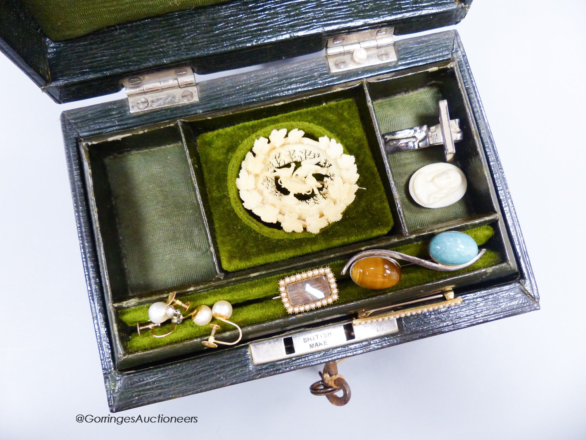 A small green leather jewellery box of assorted minor jewellery